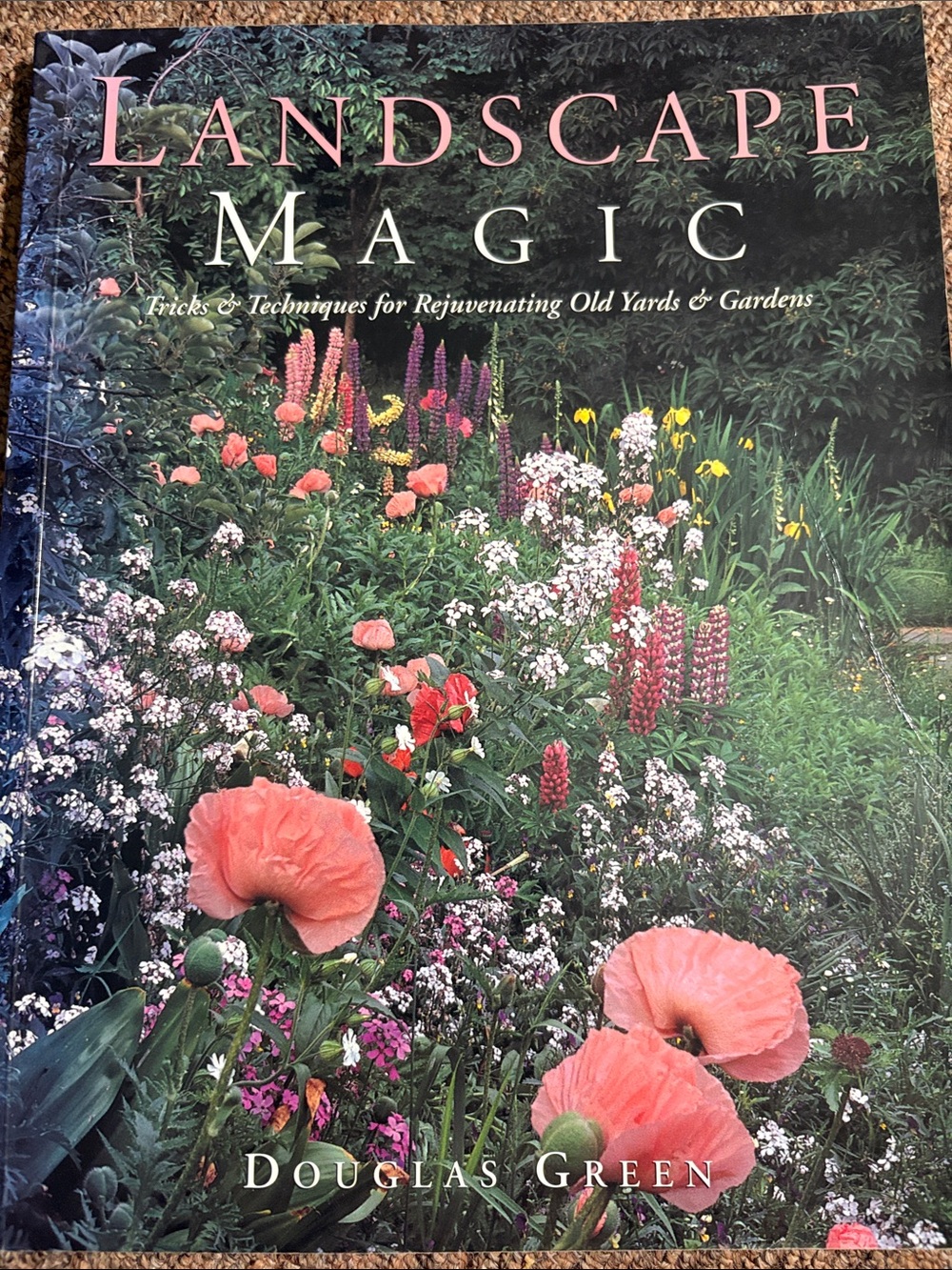 Chapter gardening book cover with pink blooms and green backdrop